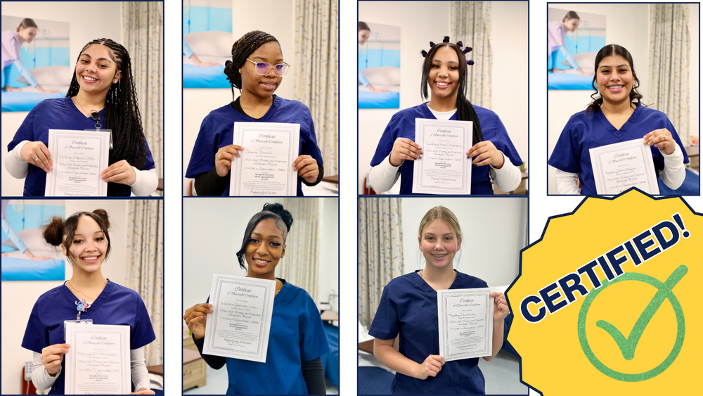 7 students in the CNA program hold up their recently earned credentials