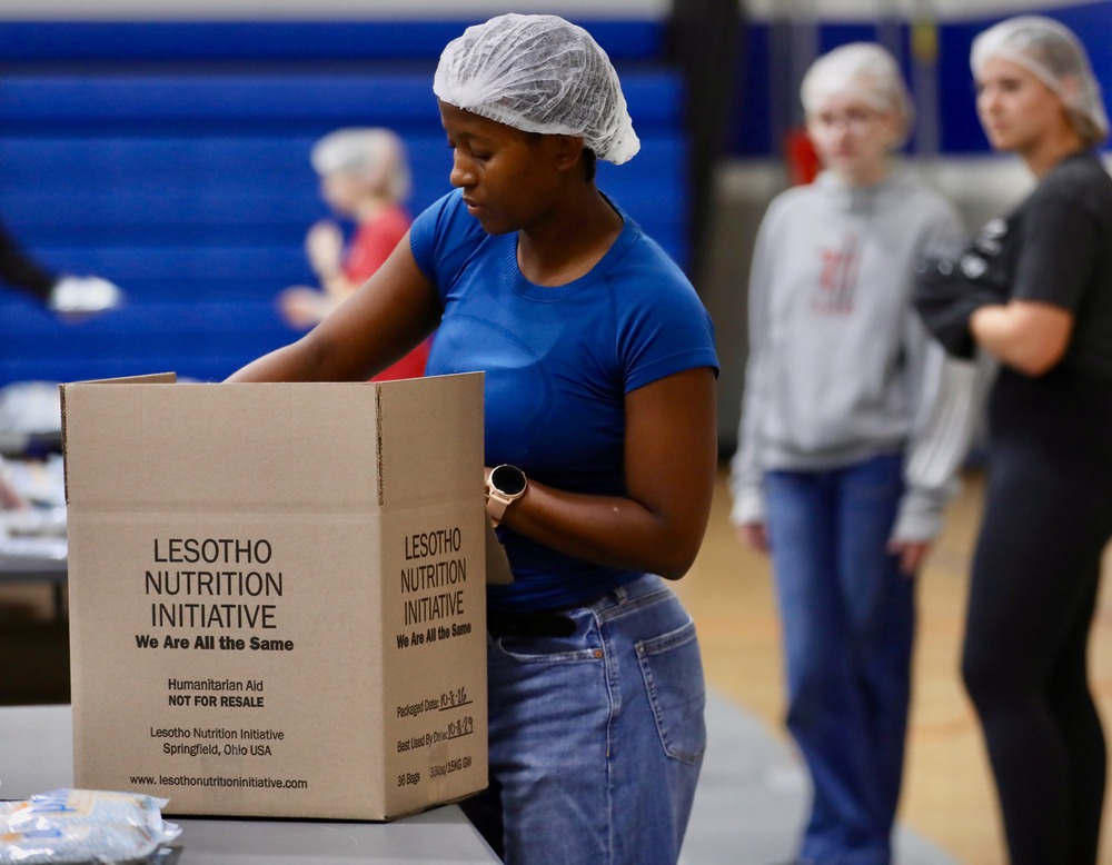 A student packs a box of food