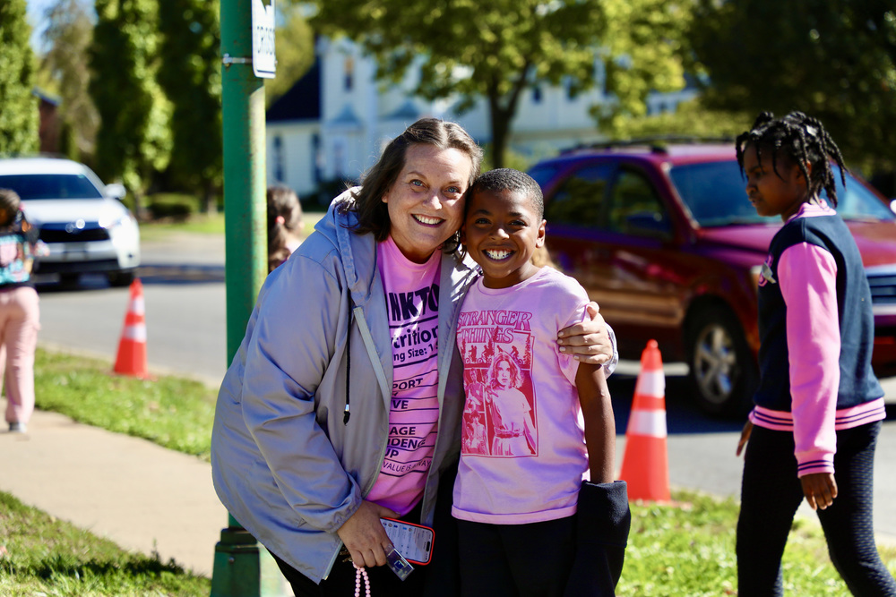 Ms. Laurie Hammontree and a Lagonda student pose for a picture wearing pink shirts