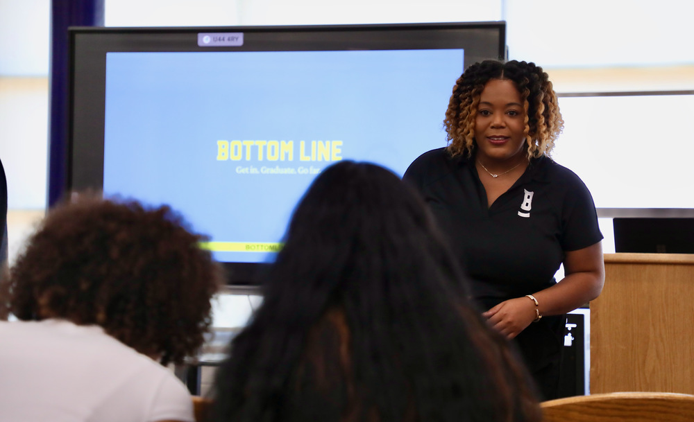A presenter gives information to students about Bottom Line