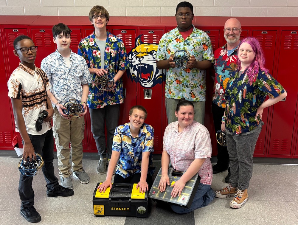 Members of the Hayward Drone Soccer Team pose for a photo in front of lockers