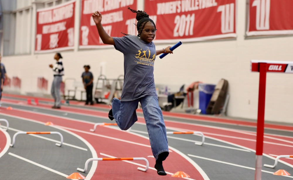 A student jumps over a hurdle at Wittenberg University