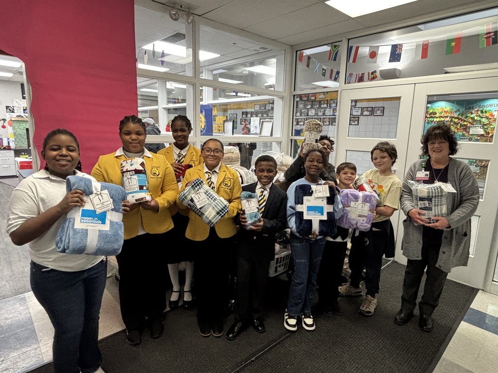 Ann Hembry of The Springfield Cancer Center accepts blanket donation from  Fulton's Jr. Lighthouse Team and Lighthouse Ambassadors