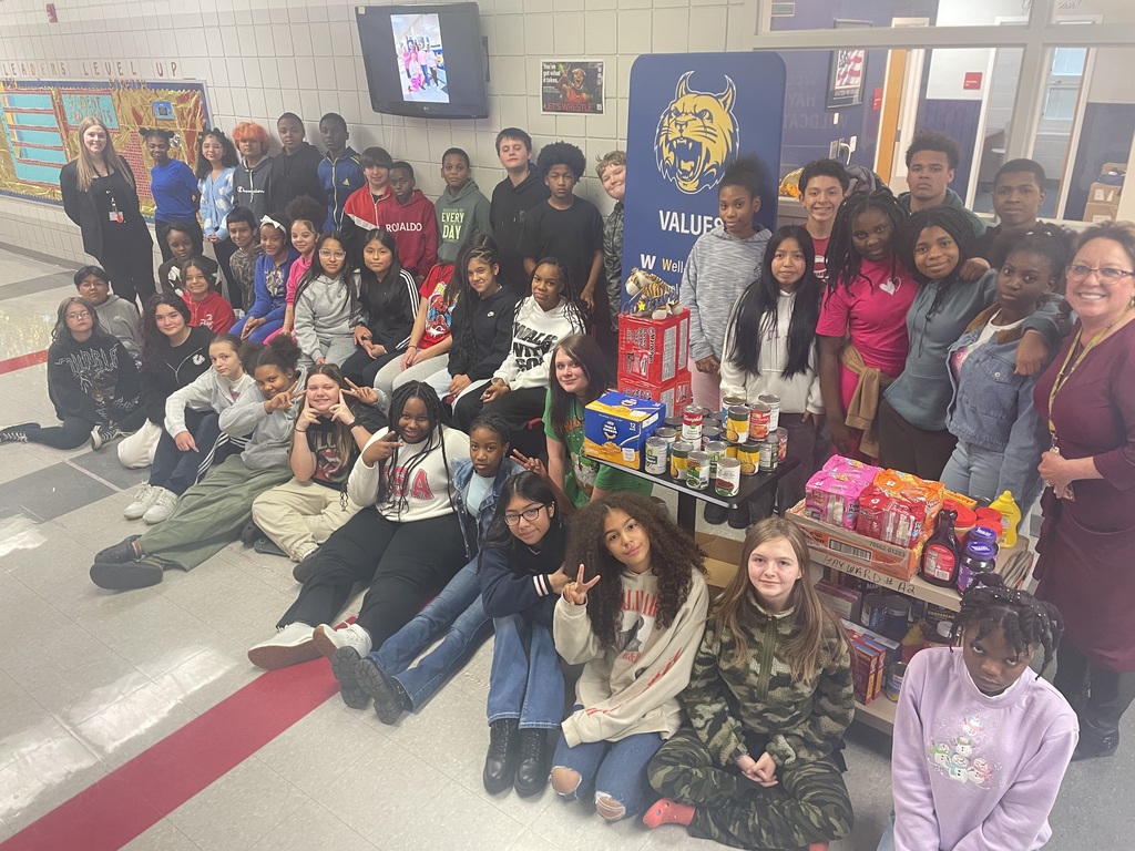 The middle school music students and staff with the donations that were collected.