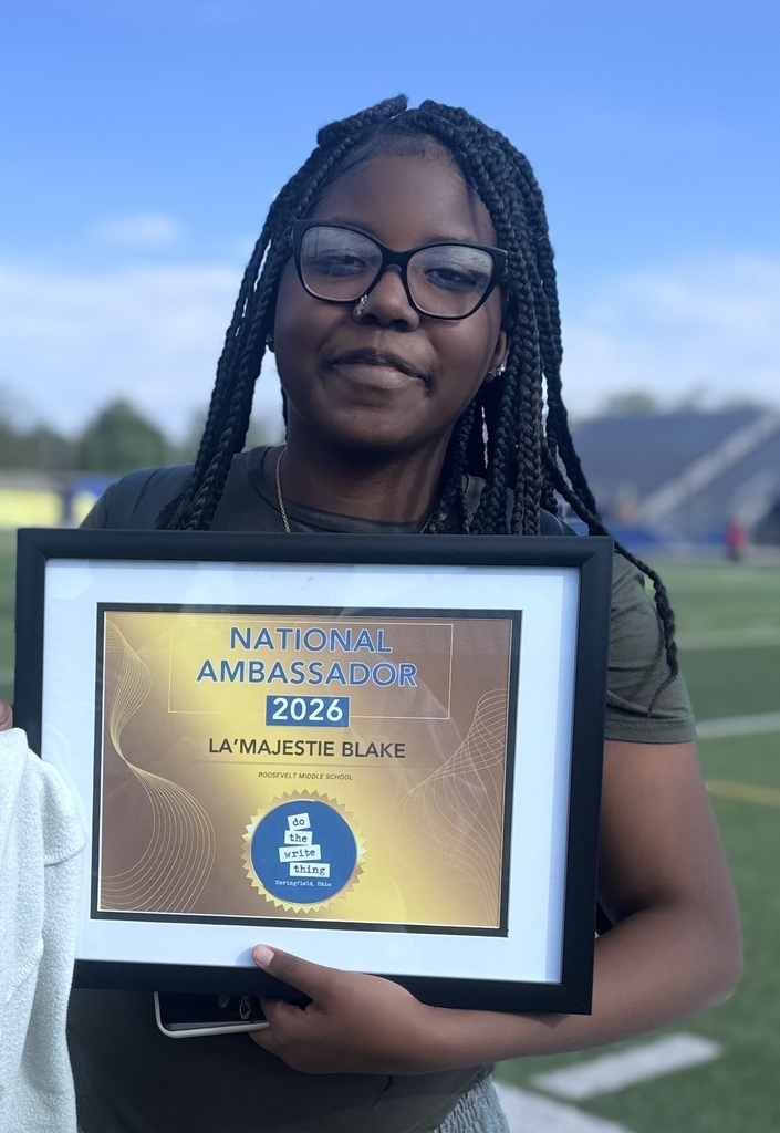Student holding an award 