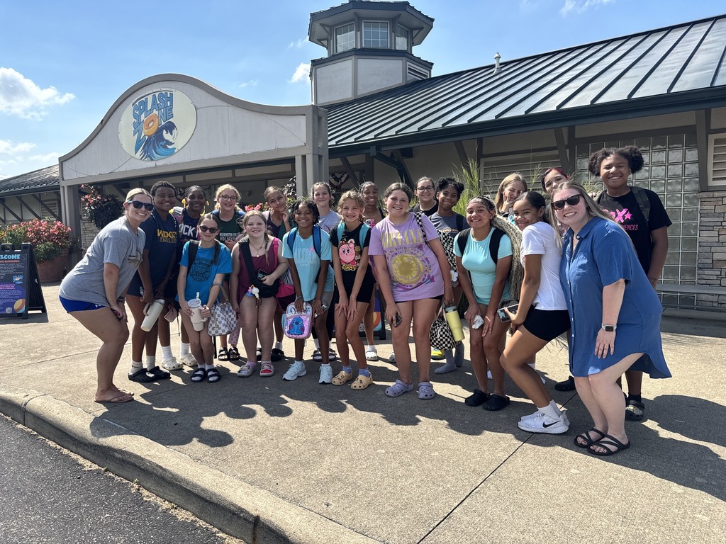 Middle school volleyball poses for a picture in front of Splash Zone