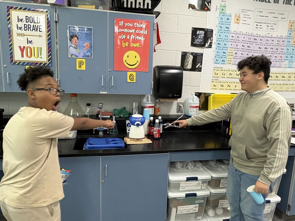 Students excitedly point to the snow cone machine they got to use for Works Perks. 