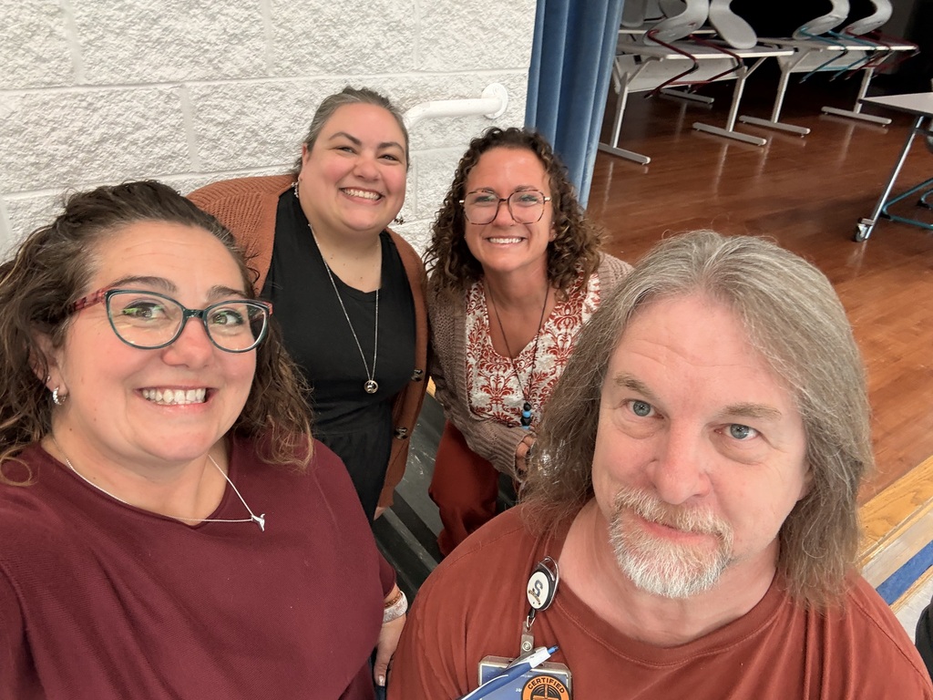 Mrs. Tynan, Ms. v,  Mrs. Barcus, and Mr. Cooper wait to greet students for breakfast.