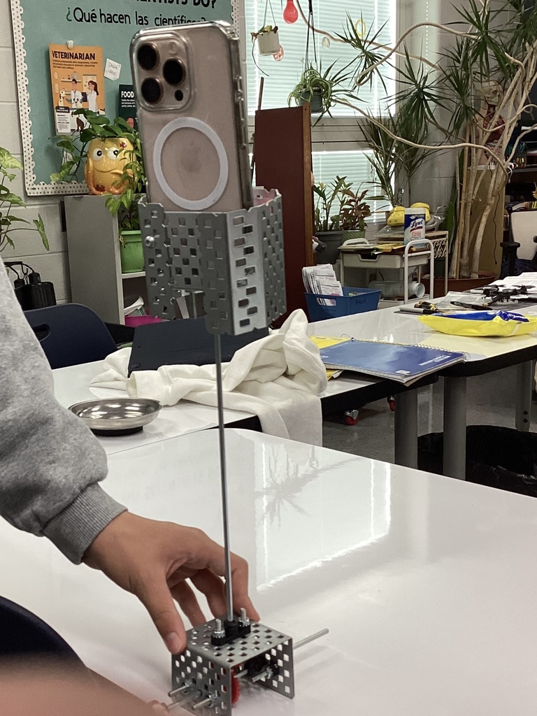 A student-made device that holds a phone and rotates. 