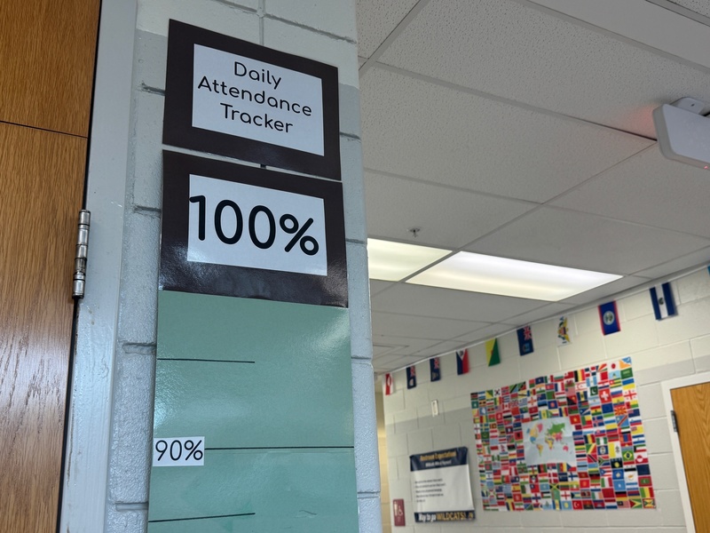An attendance scoreboard at Hayward Middle School is displayed on the wall near the front office