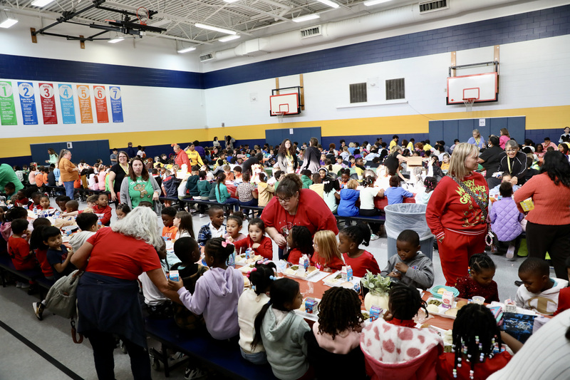 A wide shot of Fulton's longest table spanning the entire area of the gymnasium