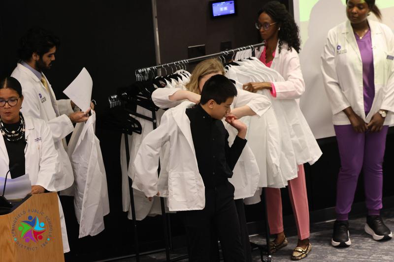 student getting white coat