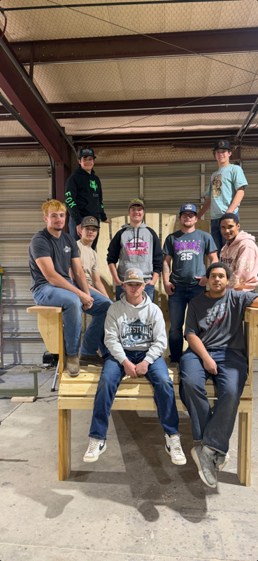 Building Trades class with giant chair they built.