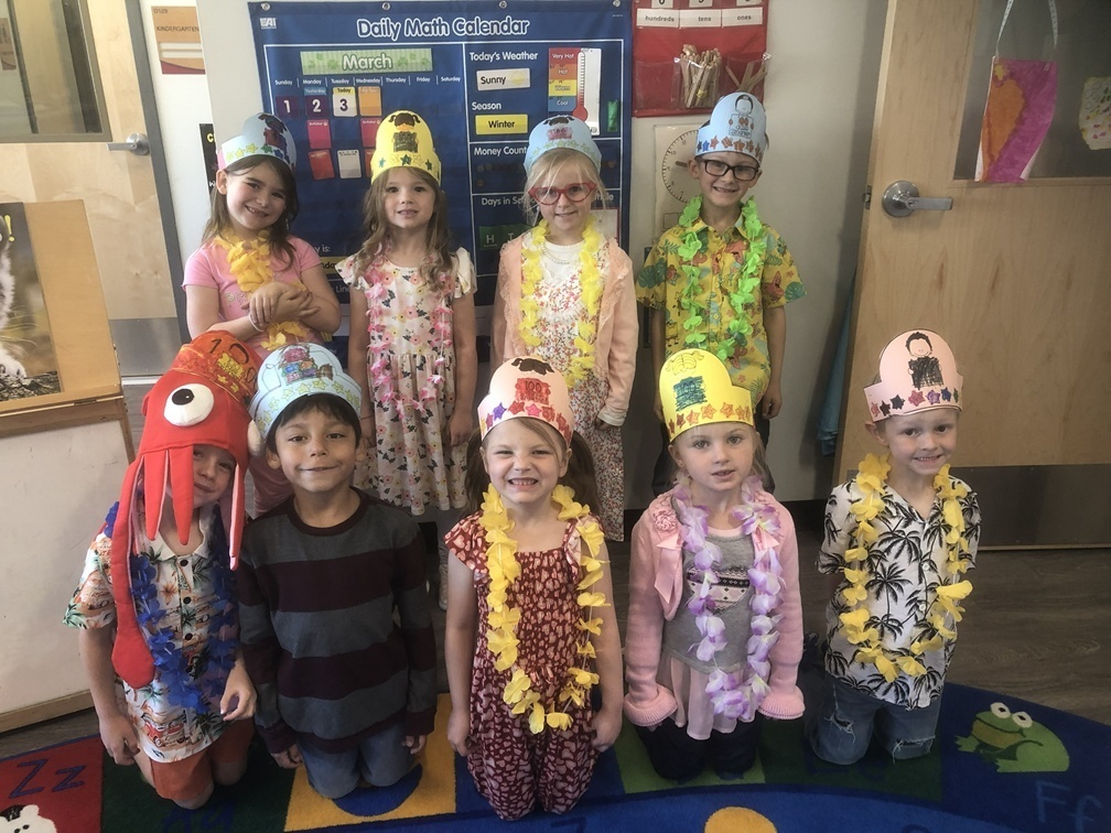 picture of students wearing leis and crowns for 100 day