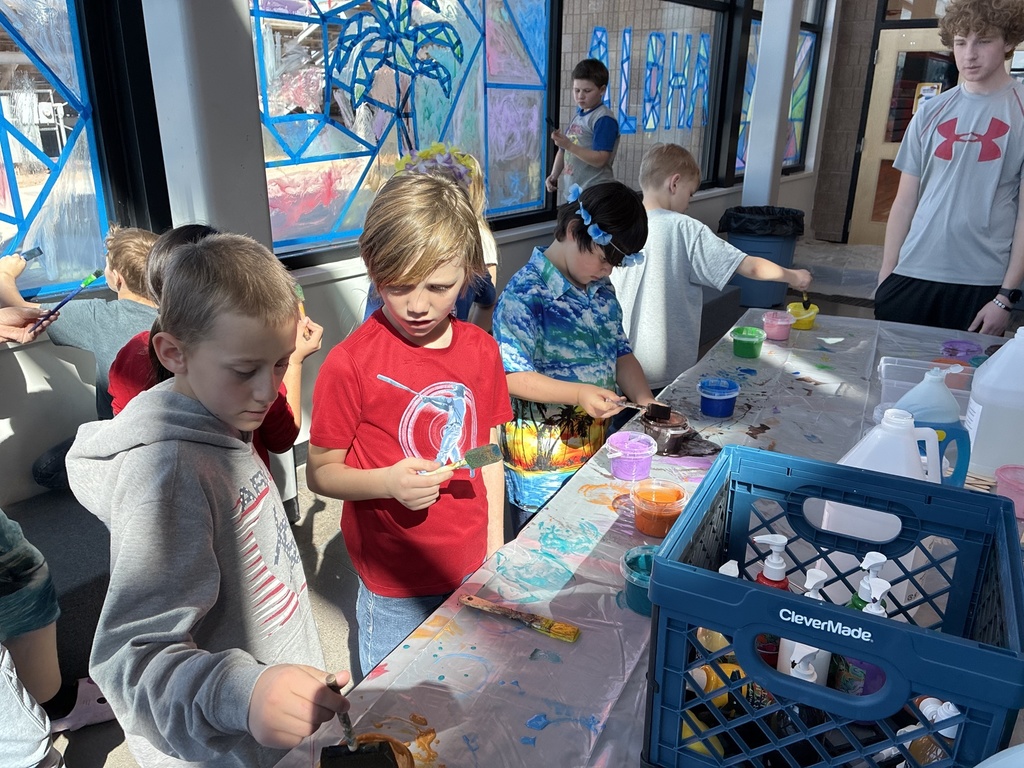 picture of students painting on windows