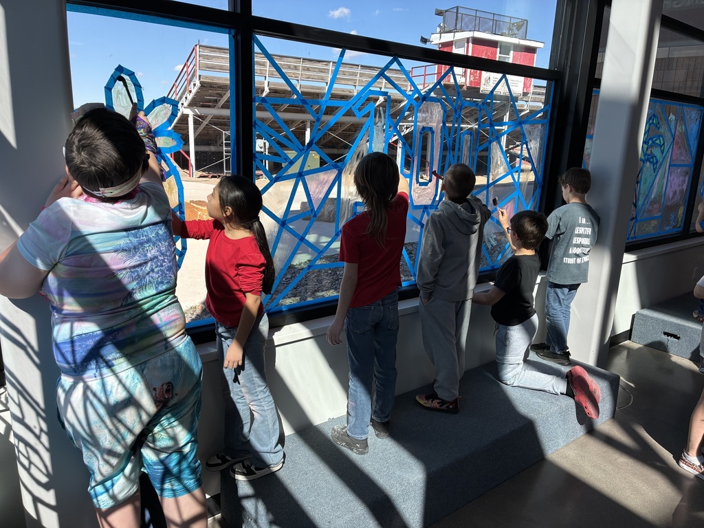 picture of students painting on windows