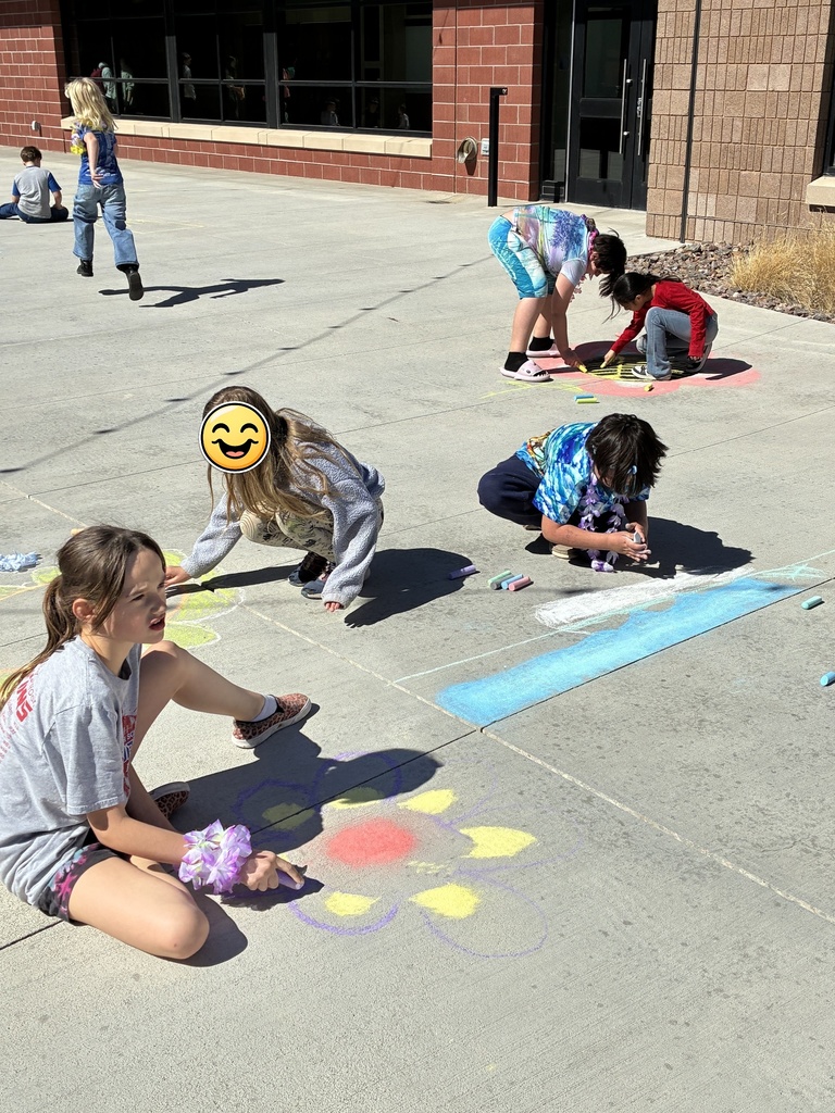 Picture of students drawing with chalk on sidewalk
