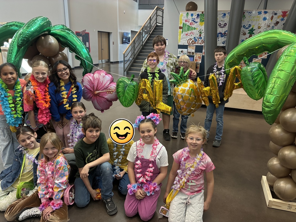 Picture of students with Hawaiian backdrop for 100th day of school