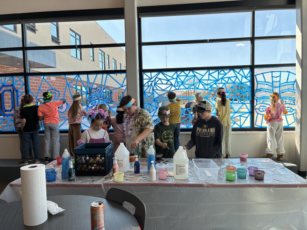 picture of students painting on windows