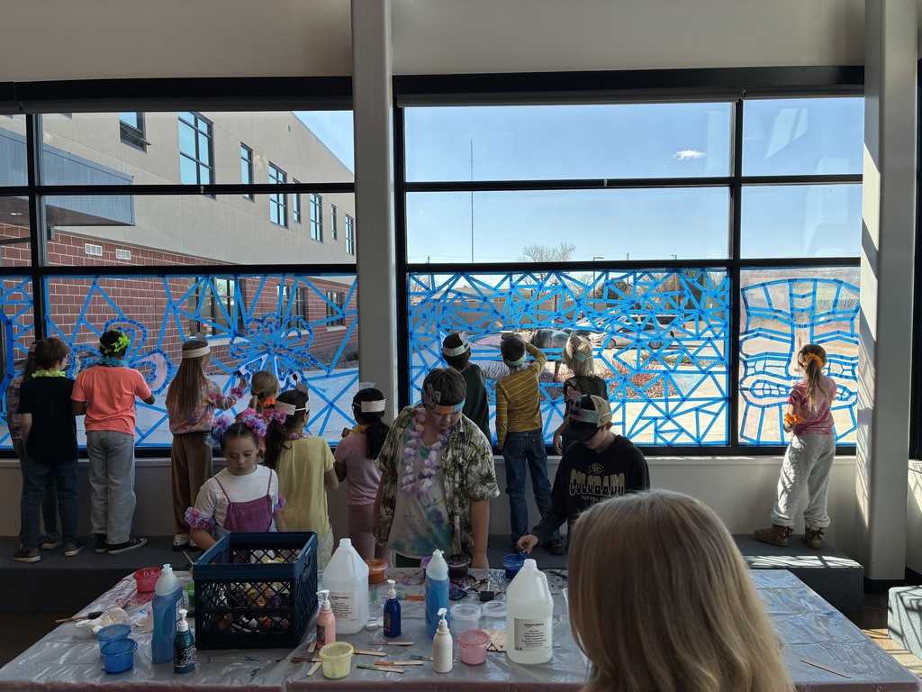 picture of students painting on windows