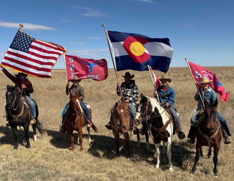 picture of five people riding horses holding USA, Colorado, & Springfield flags