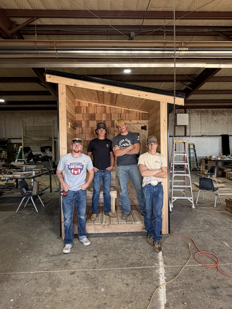picture of Building Trades II students with sauna they built