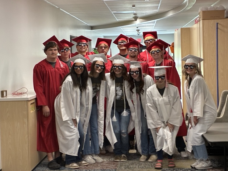 picture of seniors in cap and gowns wearing 2026 sunglasses 