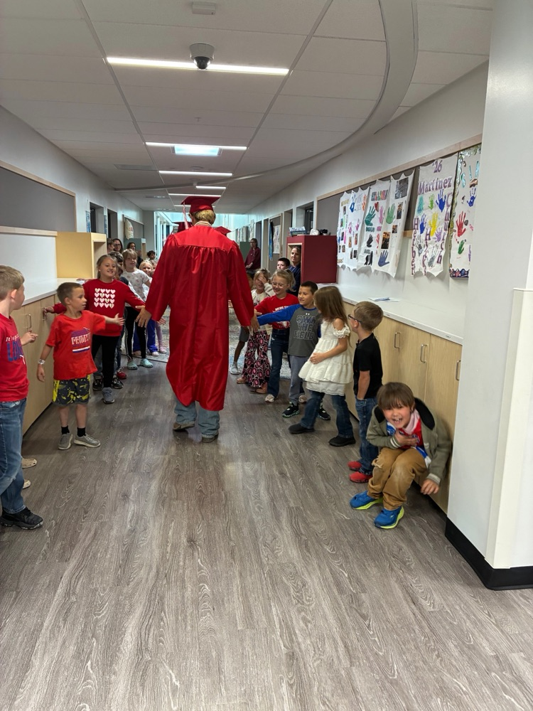 picture of senior walking down elementary hallway