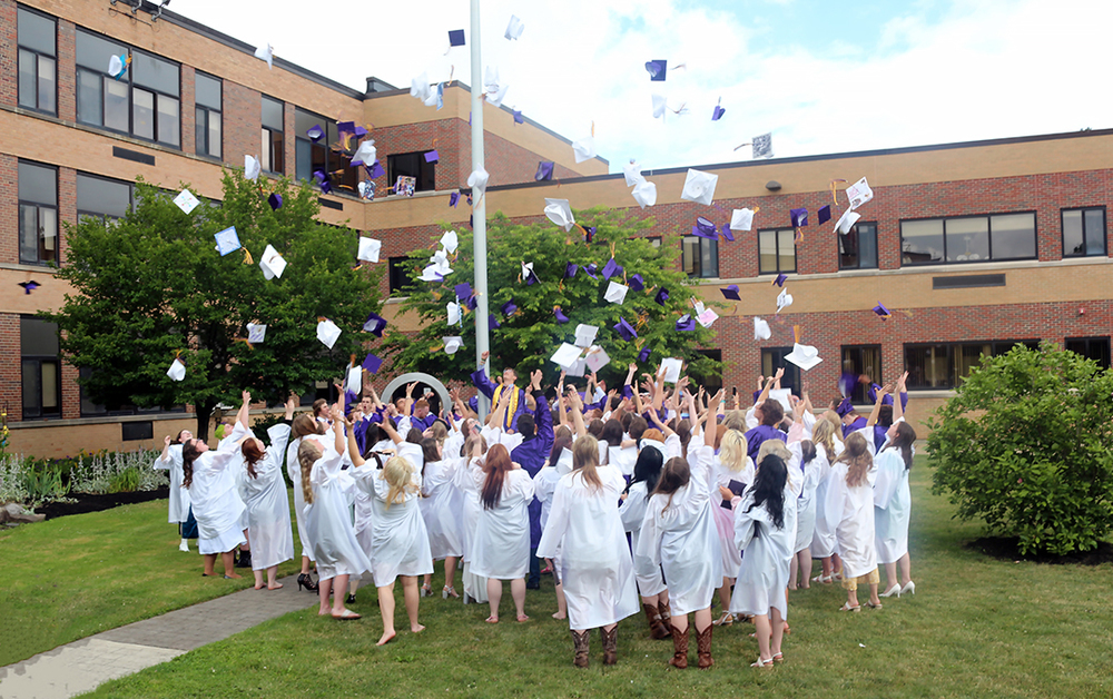 Grads toss their caps.