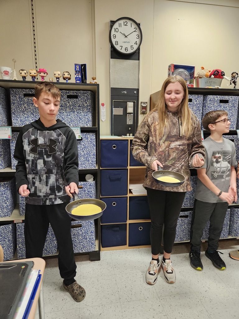 Students flip crepes.