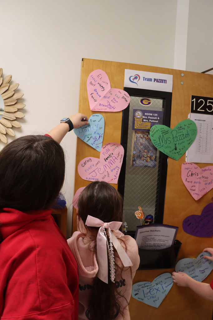 students hand up their character hearts.