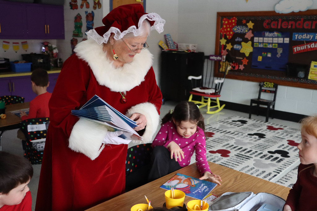 Mrs. Claus hands out books.