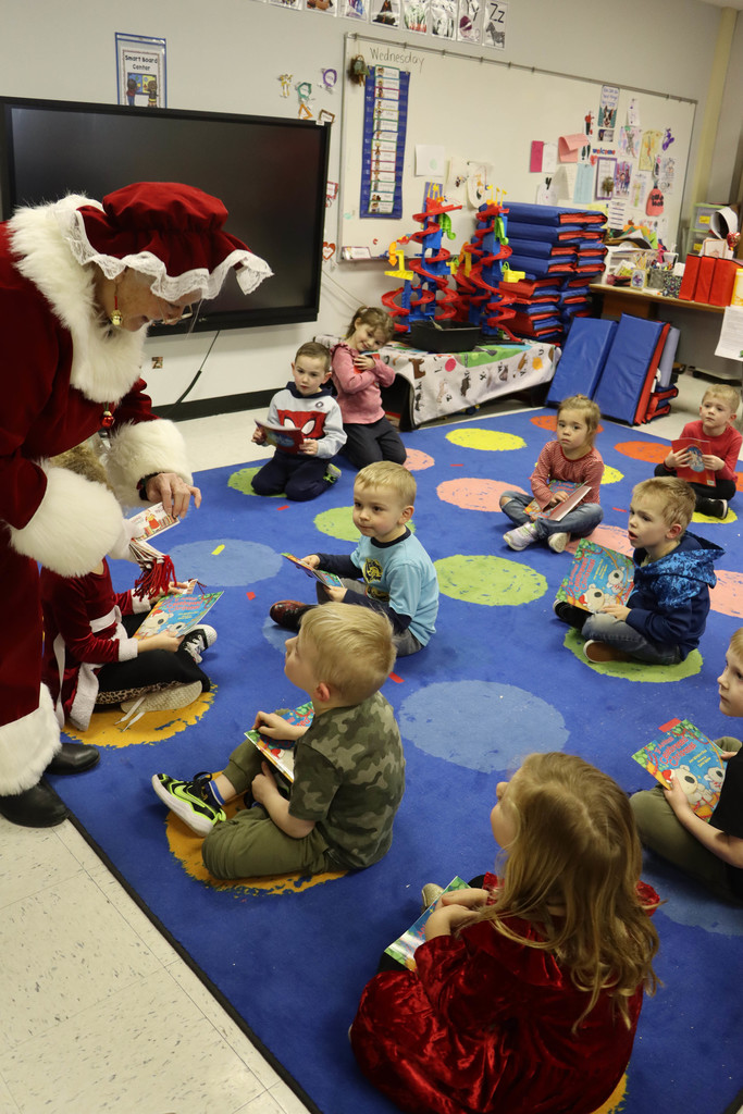 Mrs. Claus hands out bookmarks. 