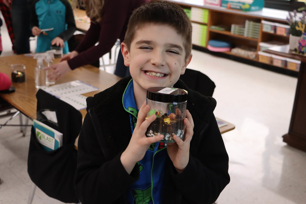 a student shows off his terrarium.