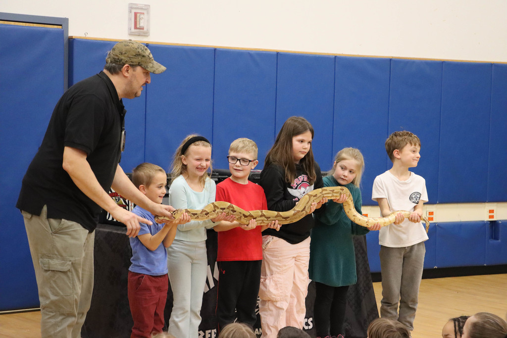 students hold a large snake