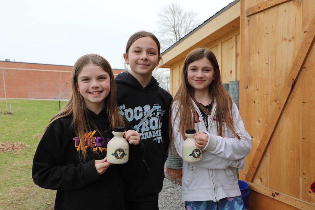 three students with syrup