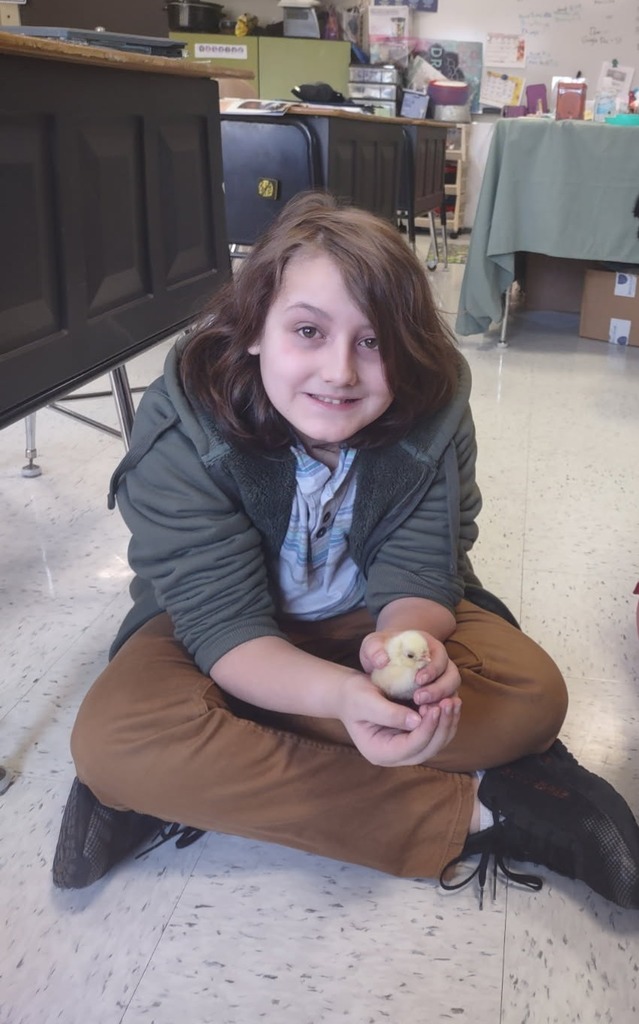 student holds a chick