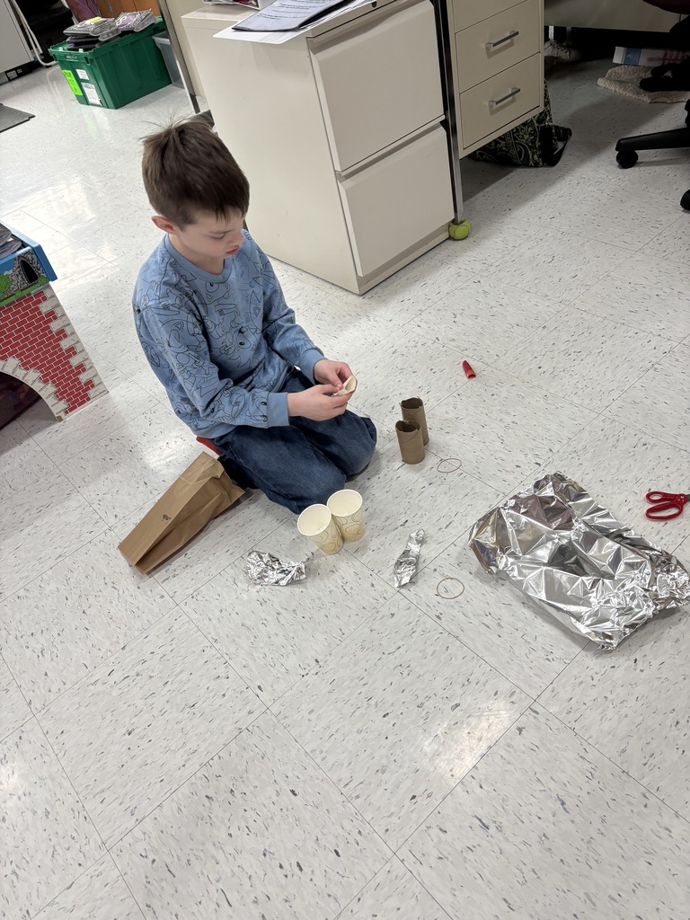 a student works on his egg drop experiment