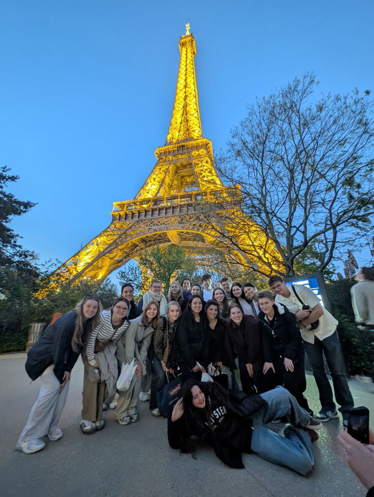 Students in front of the Eiffel Tower at night