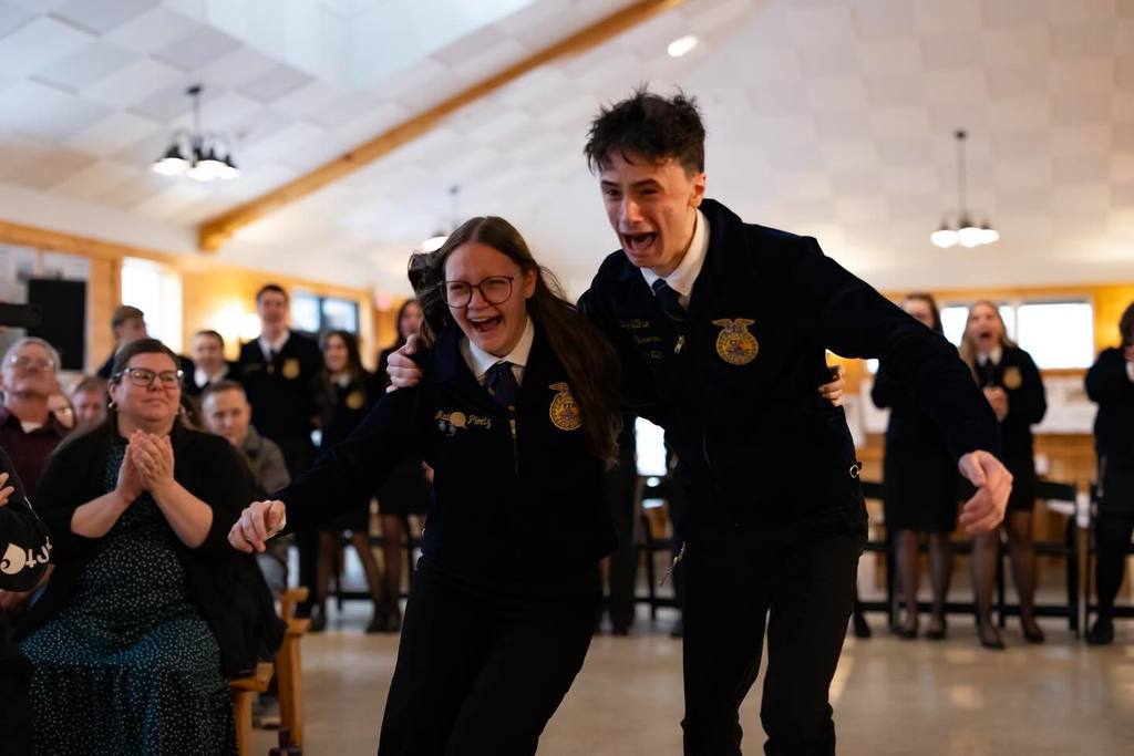 Madalynn and an FFA member cheer as she is elected. 