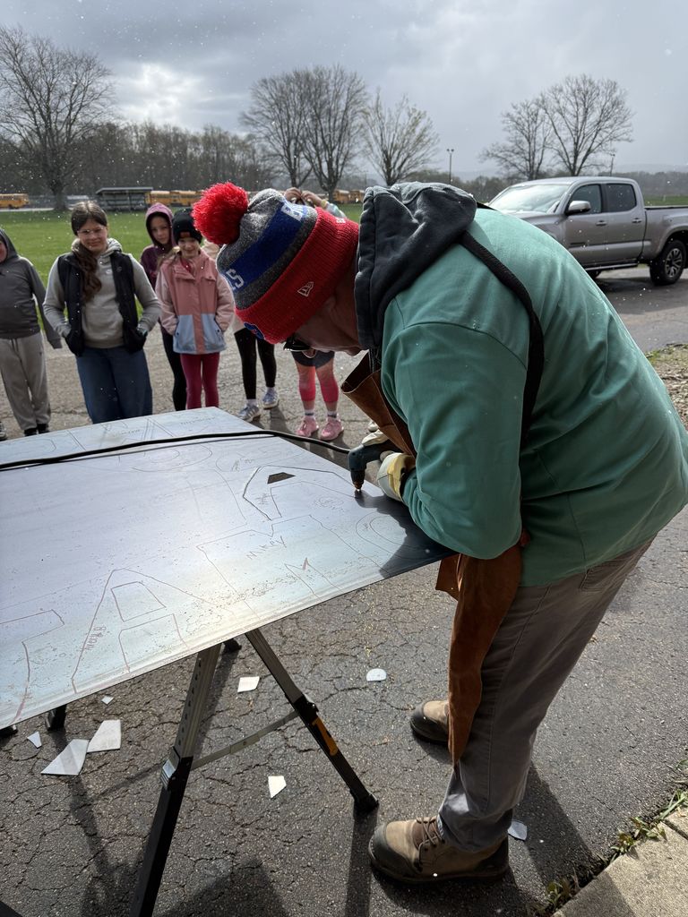 Mr. Baumgartner shows students how to plasma cut. 