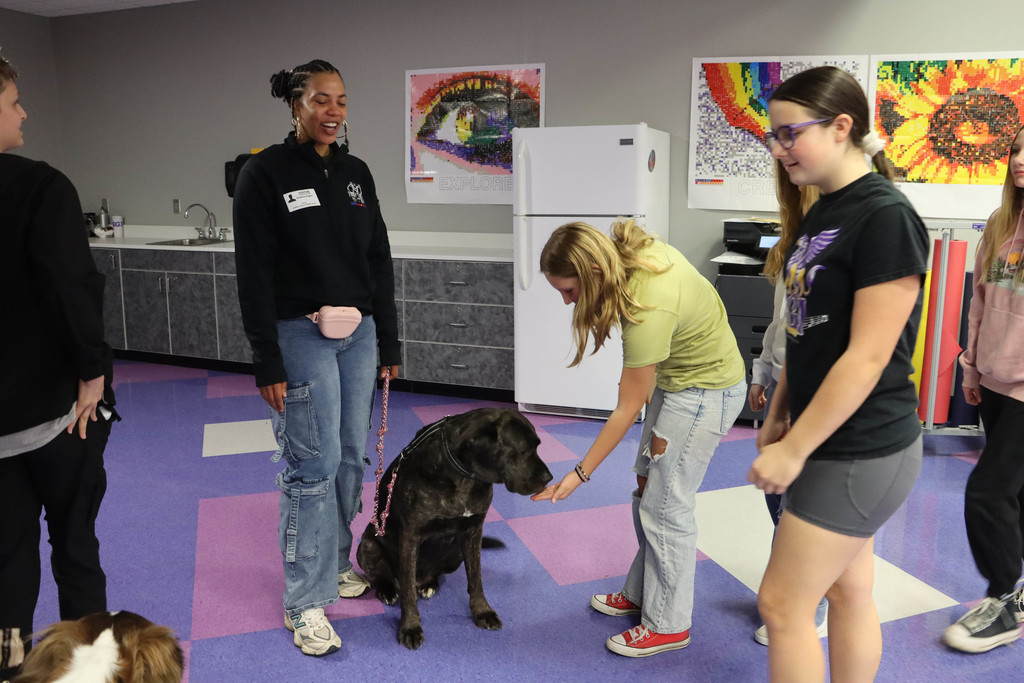 students pet the dog.