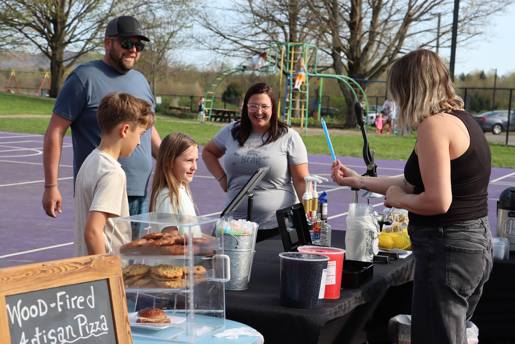 A family orders a drink from the food truck. 