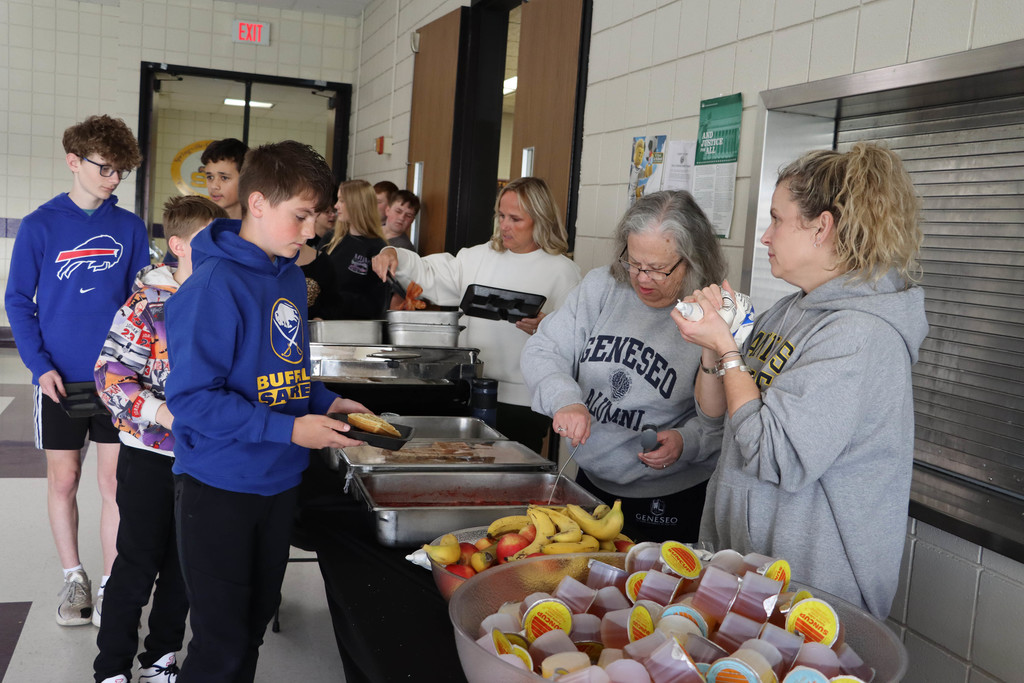 students are served breakfast by teachers. 