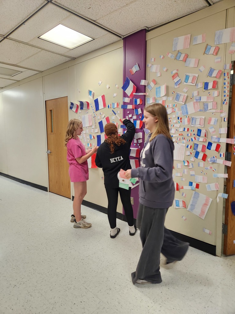 Students hang up French flags for the flag war.