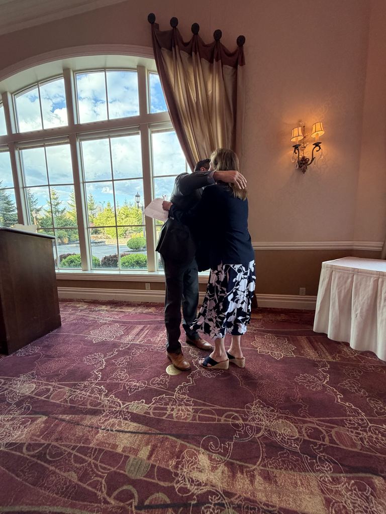 Mr. Bialasik hugs JoAnn