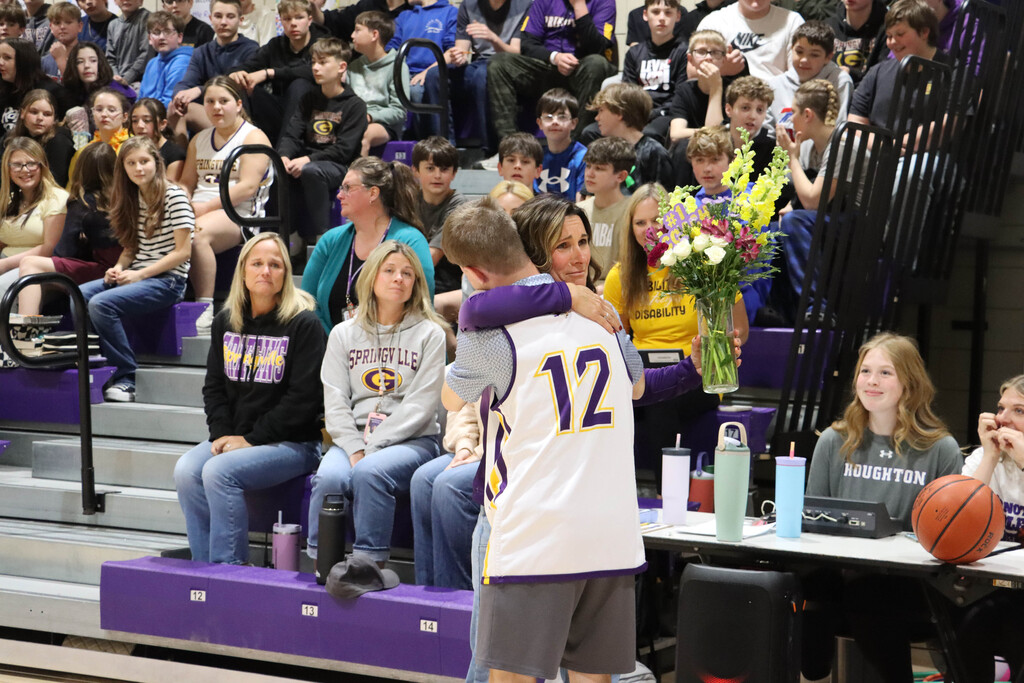 Nate gives Coach Robbnett flowers before the game.