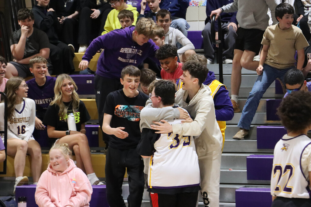 Classmates hug Dominic after the game. 