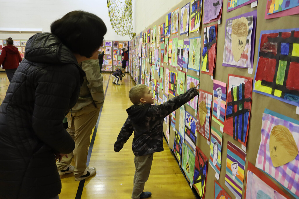 Student points to artwork.
