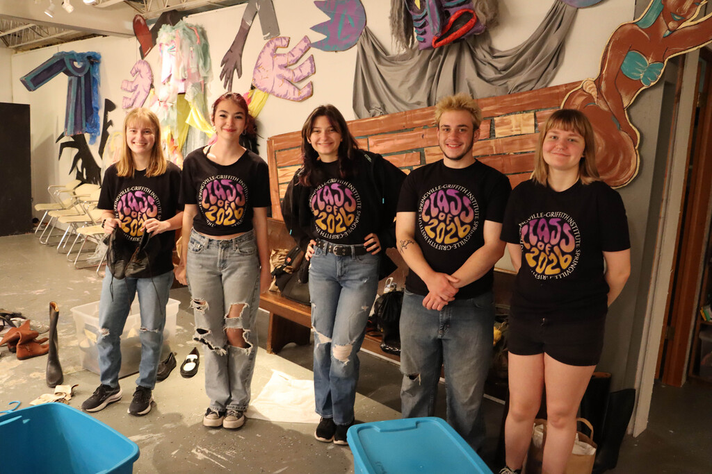 Five seniors organize the costume closet at Spark. 